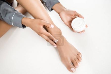 woman applying body cream