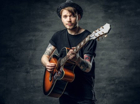 Young guitarist with tattoos