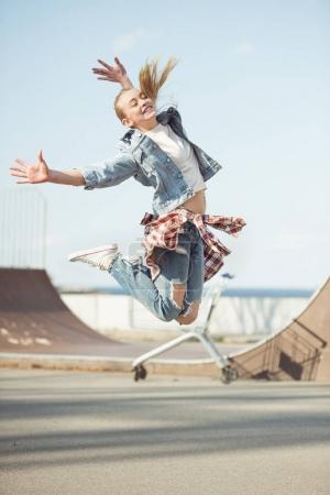 girl jumping at skateboard park