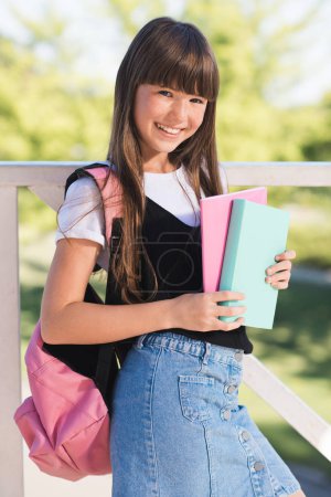 smiling teenager with books