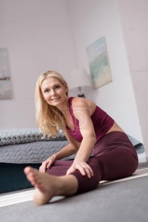 woman practicing yoga at home