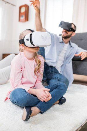 Father and daughter in virtual reality headsets