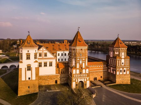 Aerial view of Medieval Mir castle complex at spring sunset. Famous landmark, UNESCO world heritage. Drone panorama of Mirsky zamok, Belarus