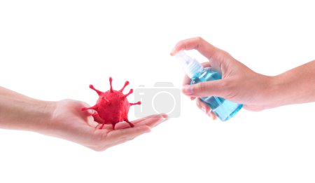 (Covid-19) Corona Virus Disease that Built by molding clay painted and hand holding alcohol spray bottle sterilize with clipping path.