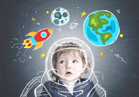 Astonished cute little boy in a suit, space dream