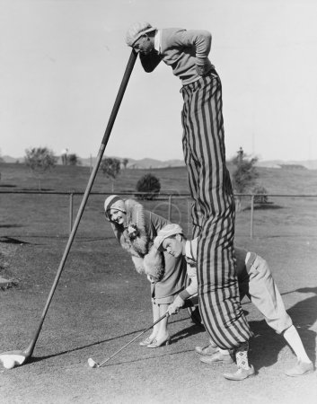 Golf game with man on stilts