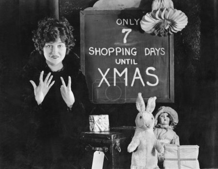 Woman and sign with number of shopping days until Christmas