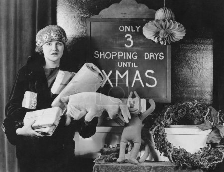 Female shopper and sign with number of shopping days until Christmas