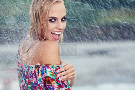 Portrait of young beautiful woman in rain