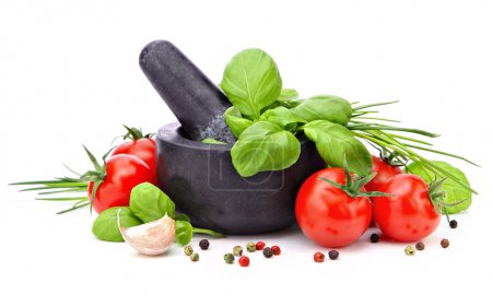 Mortar with basil, garlic, tomatoes and pepper