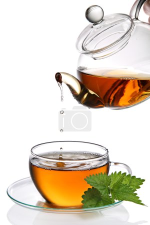 Tea dripping into cup (clipping path)