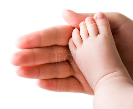 Baby foot on his mothers palm in isolation