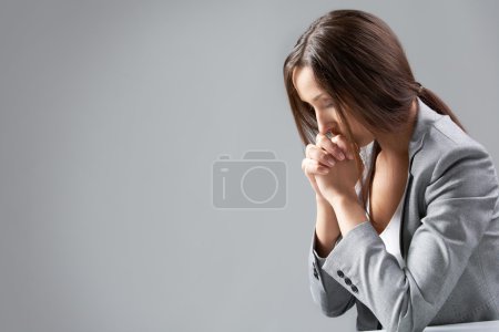 Praying businesswoman