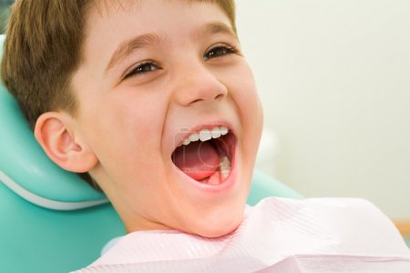 Youngster with his mouth wide open during checkup at the dentist's
