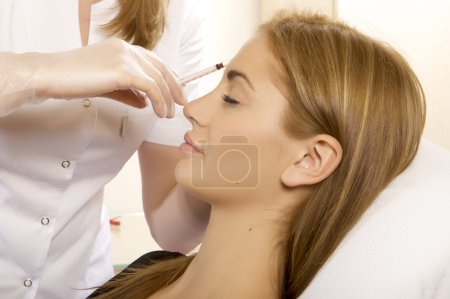 Young beautiful woman having an injection