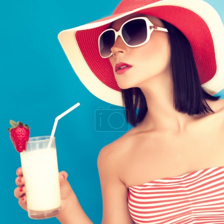 Sensual woman with sunglasses drinking a cocktail