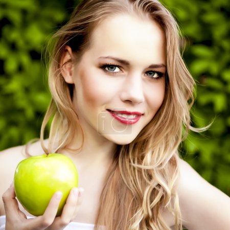 Portrait of a beautiful girl with an apple