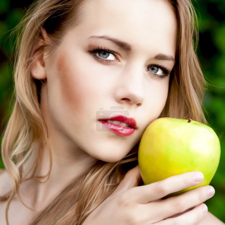 Sensual portrait of a girl with an apple