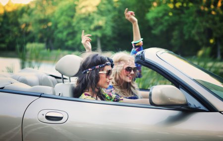 Smiling women in a cabriolet