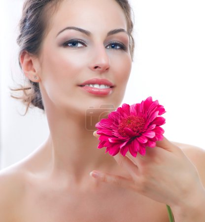 Beautiful Young Woman Portrait with Red Gerbera Flower. Spa