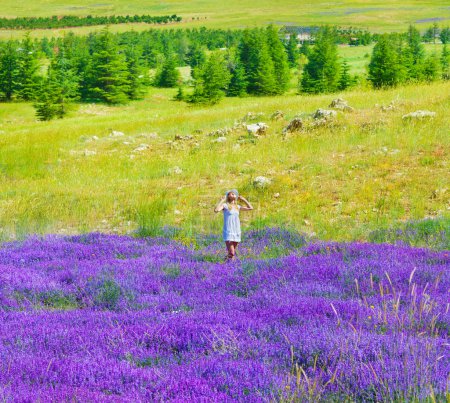 Beautiful girl enjoying lavender field
